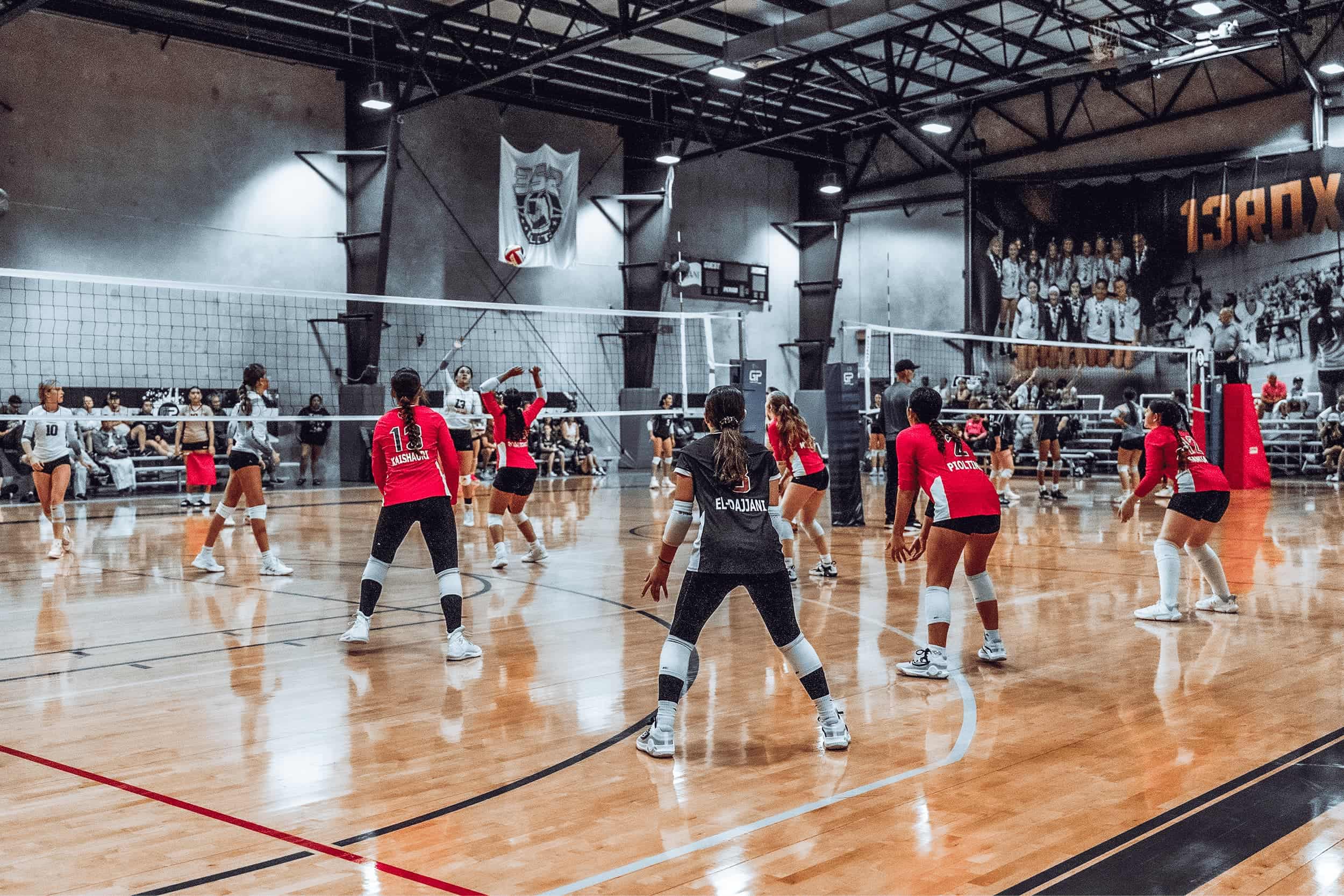 Evolution Volleyball athletes competing on court.